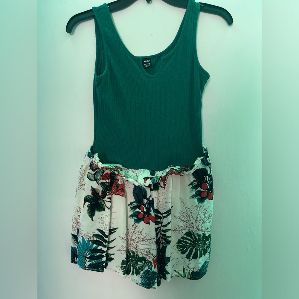 I’m selling a green and floral print romper from SHEIN that is a size large.